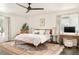 Bright bedroom with a patterned rug, desk, and large windows with curtains at 40 S Dexter St, Denver, CO 80246