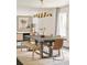 Bright dining room featuring modern lighting, a large table, and a neutral rug at 40 S Dexter St, Denver, CO 80246