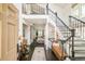 Inviting foyer featuring hardwood floors, staircase, and access to the living area at 40 S Dexter St, Denver, CO 80246
