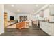 Spacious living room featuring a kitchenette, dark floors and comfortable seating at 40 S Dexter St, Denver, CO 80246