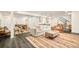Large, bright living room featuring stylish decor, a partial kitchen area, and access to stairs at 40 S Dexter St, Denver, CO 80246