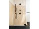 Modern shower featuring wood tile, matte black fixtures, and a built-in seat at 40 S Dexter St, Denver, CO 80246