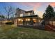 Well-maintained backyard featuring a covered patio area and lush green lawn at 5034 E Otero Cir, Centennial, CO 80122