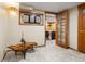 Finished basement area with hardwood accent table and a glimpse into the game room at 5034 E Otero Cir, Centennial, CO 80122