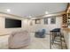 Large finished basement with media area, bean bag chairs, and bar with seating at 5034 E Otero Cir, Centennial, CO 80122
