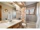 Bathroom featuring tiled shower, peach shower curtain, and decorative mirrors at 5034 E Otero Cir, Centennial, CO 80122
