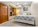 Cozy bedroom featuring a built-in bookcase and comfortable bedding and carpet at 5034 E Otero Cir, Centennial, CO 80122