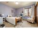 Charming bedroom featuring light purple walls, carpet, and a comfy chair at 5034 E Otero Cir, Centennial, CO 80122