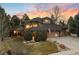 Stunning exterior view of a home showcasing its unique architecture and lush landscaping at sunset at 5034 E Otero Cir, Centennial, CO 80122