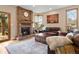 Cozy living room boasts a brick fireplace, hardwood floors, and comfortable seating with a decorative rug at 5034 E Otero Cir, Centennial, CO 80122