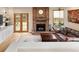 Comfortable living room with hardwood floors, brick fireplace, and walkout doors to the exterior at 5034 E Otero Cir, Centennial, CO 80122