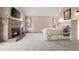 Large main bedroom features brick fireplace, tv, and natural lighting at 5034 E Otero Cir, Centennial, CO 80122