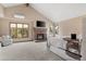 Comfortable main bedroom featuring brick fireplace, tv, and large windows at 5034 E Otero Cir, Centennial, CO 80122