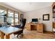 This office features hardwood floors, a beautiful wood desk, and bright natural light at 5034 E Otero Cir, Centennial, CO 80122