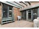 Private patio area with brick walls and sliding glass doors leading indoors at 5034 E Otero Cir, Centennial, CO 80122