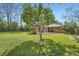 Lush backyard with mature trees, including back patio at 4490 Balsam St, Wheat Ridge, CO 80033