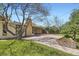 Charming home exterior with mature trees, and covered back patio at 4490 Balsam St, Wheat Ridge, CO 80033