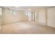 Finished basement with carpet, storage, and natural light from two large windows at 4490 Balsam St, Wheat Ridge, CO 80033