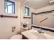 Bathroom featuring blue tile, vintage fixtures, and shower at 4490 Balsam St, Wheat Ridge, CO 80033