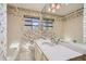 Bright bathroom with floral wallpaper, a marble countertop, and lots of natural light at 4490 Balsam St, Wheat Ridge, CO 80033