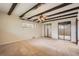 Spacious bedroom featuring beamed ceilings, ceiling fan, and large mirrored closets at 4490 Balsam St, Wheat Ridge, CO 80033