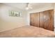 Comfortable bedroom with a window and a large closet with folding doors at 4490 Balsam St, Wheat Ridge, CO 80033