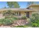 Inviting home entrance featuring brick accents, well-manicured landscaping, and a secure front door at 4490 Balsam St, Wheat Ridge, CO 80033