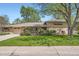 Charming single Gathering home with a brick facade, well-maintained lawn, and mature trees casting shadows at 4490 Balsam St, Wheat Ridge, CO 80033