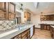 Charming kitchen with vintage wood cabinetry, a tile backsplash, a skylight, and plenty of natural light at 4490 Balsam St, Wheat Ridge, CO 80033