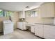 Laundry room with storage and shelving, including vintage washer and dryer at 4490 Balsam St, Wheat Ridge, CO 80033