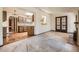 Open concept living room that features a kitchen, brick fireplace, and outdoor access at 4490 Balsam St, Wheat Ridge, CO 80033