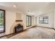 Comfortable living room showcasing a brick fireplace, and picturesque views from many windows at 4490 Balsam St, Wheat Ridge, CO 80033
