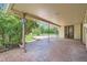 Covered patio area with brick flooring, and lush backyard at 4490 Balsam St, Wheat Ridge, CO 80033