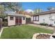 Backyard featuring artificial turf, storage shed, and patio with pavers at 6235 W Floyd Ave, Denver, CO 80227