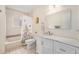 Charming bathroom with a vanity and tiled bathtub at 6235 W Floyd Ave, Denver, CO 80227