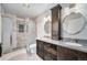 Modern bathroom with dual sinks, tiled shower, and stylish fixtures at 6235 W Floyd Ave, Denver, CO 80227