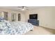 Primary bedroom featuring neutral walls and a TV at 6235 W Floyd Ave, Denver, CO 80227