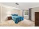 Bright bedroom featuring a patterned comforter, window and neutral carpet at 6235 W Floyd Ave, Denver, CO 80227