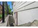 Staircase leading to the exterior entrance of the home, with secure railing at 6235 W Floyd Ave, Denver, CO 80227