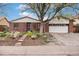 Charming brick home with landscaped front yard, stepping stone pathway, and mature shade tree at 6235 W Floyd Ave, Denver, CO 80227