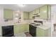Compact kitchen featuring wood cabinets, laminate countertops, and essential appliances at 6235 W Floyd Ave, Denver, CO 80227