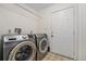 Functional laundry room with modern washer and dryer units at 6235 W Floyd Ave, Denver, CO 80227