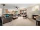 Bright living area showcasing a fireplace, bay windows, and flowing layout into the kitchen at 6235 W Floyd Ave, Denver, CO 80227