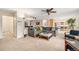 Spacious living area with comfortable seating, ceiling fan, and an open view into the kitchen at 6235 W Floyd Ave, Denver, CO 80227