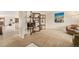 Open concept living room with decor shelving at 6235 W Floyd Ave, Denver, CO 80227