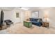 Living room featuring neutral carpet, a sofa, television and bright light at 6235 W Floyd Ave, Denver, CO 80227