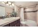 Bathroom featuring shower/tub combination, granite counters, and tile flooring at 6508 Moss Cir, Arvada, CO 80007