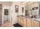 Well-lit bathroom featuring granite counters, double sinks, a shower and a walk-in closet at 6508 Moss Cir, Arvada, CO 80007