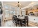 Bright dining area with large windows, seamlessly connected to the kitchen, perfect for Gathering meals at 6508 Moss Cir, Arvada, CO 80007