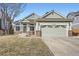 Charming single-Gathering home featuring a well-manicured lawn and an attached two-car garage at 6508 Moss Cir, Arvada, CO 80007